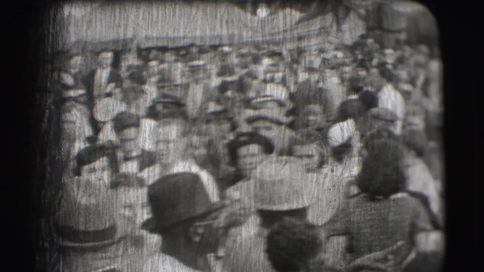Crowded 1948 Sarasota circus entrance scene with visitors in hats and formal daywear seen through worn 8mm film texture.