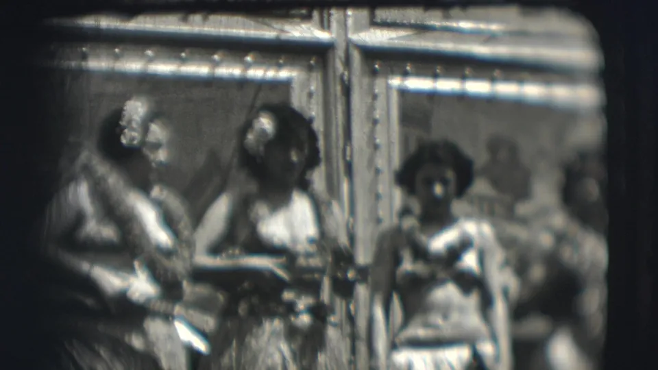 Three hula-style performers are visible on a stage or platform in the Ringling Brothers Sarasota home movie.