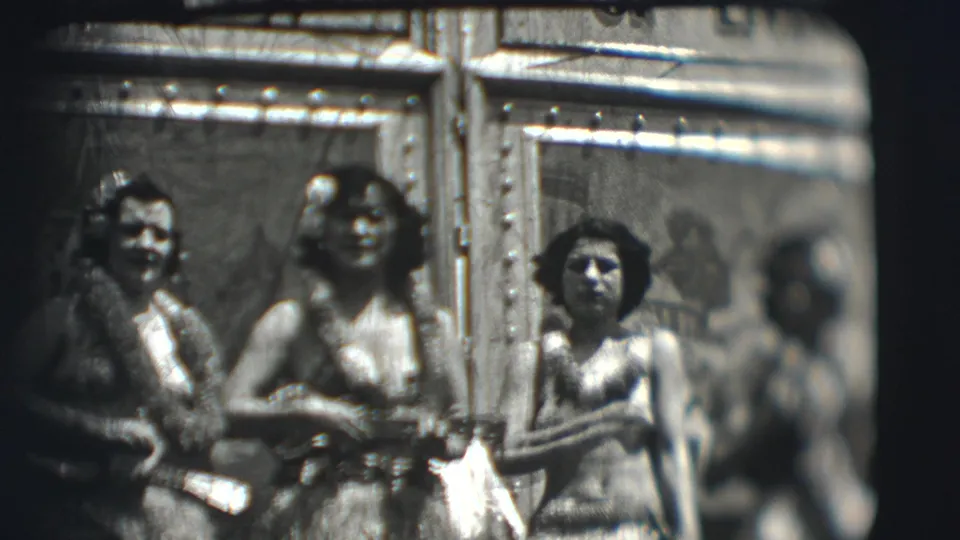 1948 Ringling Sarasota home-movie frame of costumed women posing, framed by soft focus and film grain.
