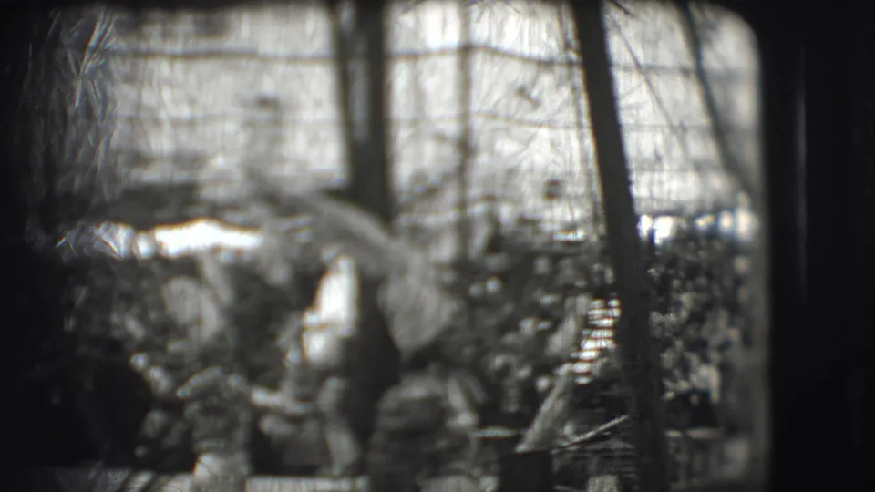 1948 Sarasota circus home-movie frame showing costumed performers in shiny outfits moving past a fixed spectator viewpoint.