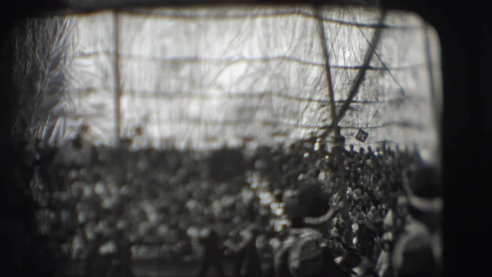 A soft, scratched 8mm view of the 1948 Sarasota circus crowd, with indistinct figures gathered around the arena.
