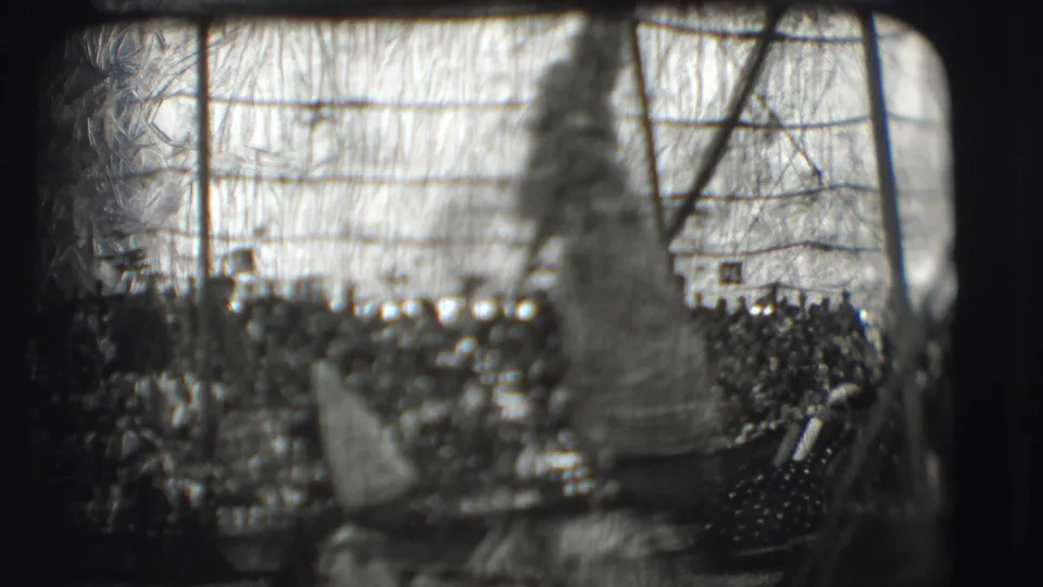 1948 8mm view inside a Ringling Brothers circus tent in Sarasota, with tall-hatted figures before a dense audience.