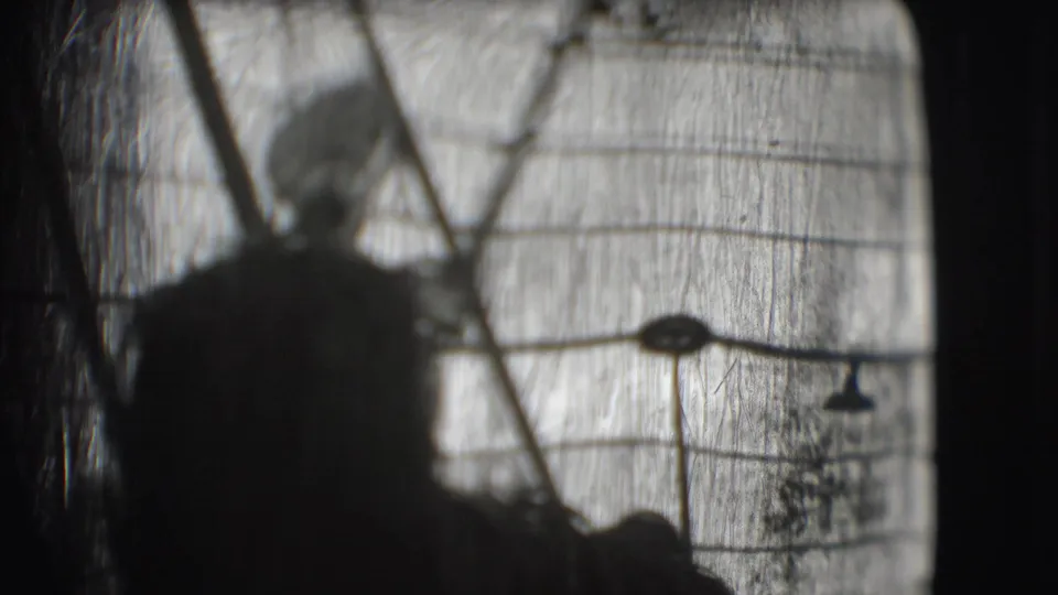 1948 Sarasota circus footage showing a dark silhouetted figure behind a patterned tent or screen-like structure.