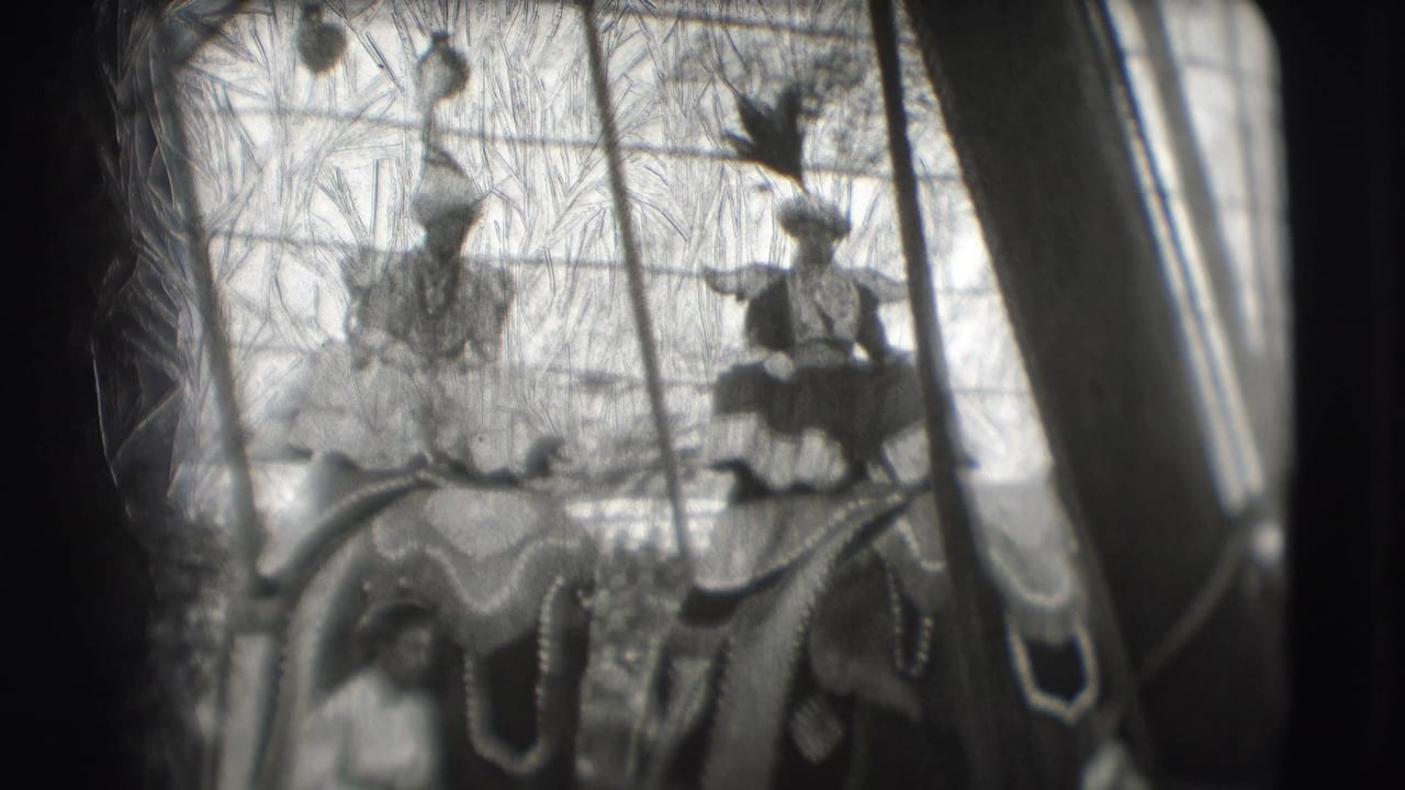Decorated elephants carry costumed riders inside a circus tent.