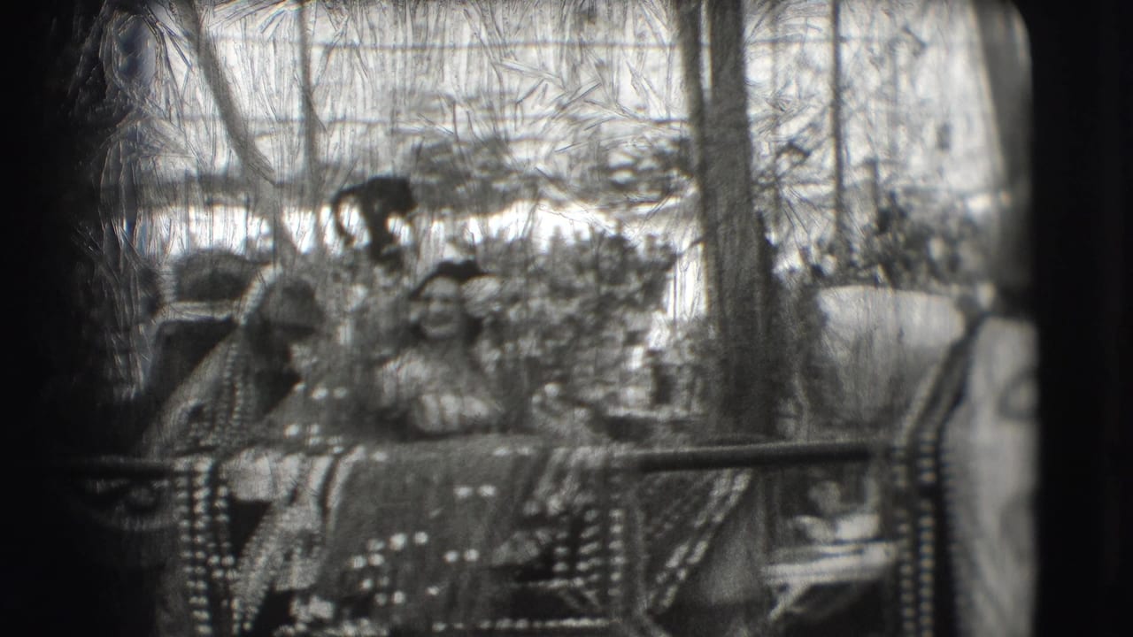 Costumed riders sit on a decorated elephant or cart inside a circus ring.