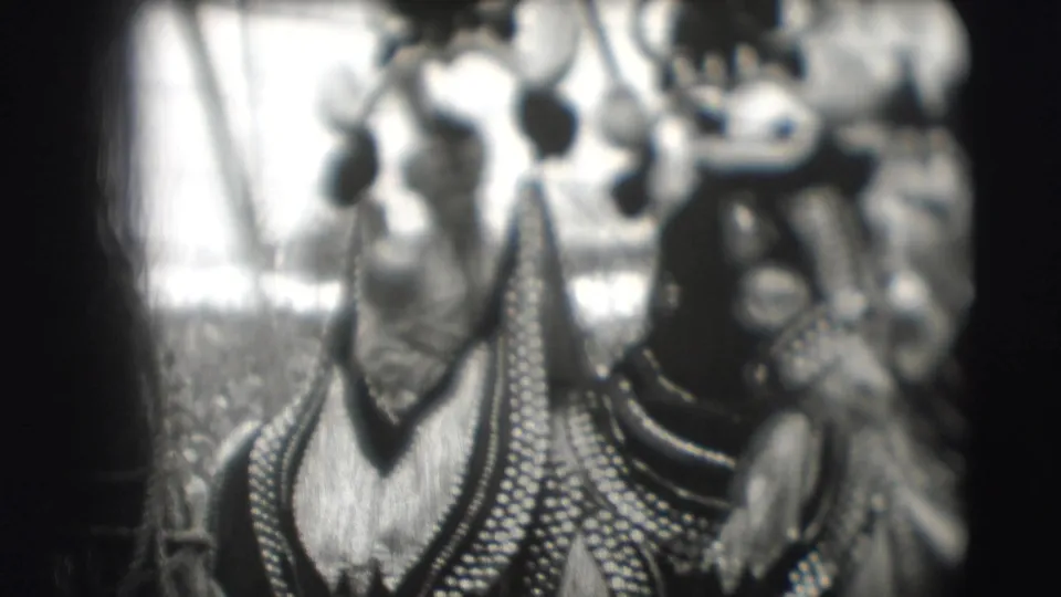 Close 1948 Ringling Brothers Sarasota view of a decorated elephant with a performer above, filmed in soft black-and-white 8mm.