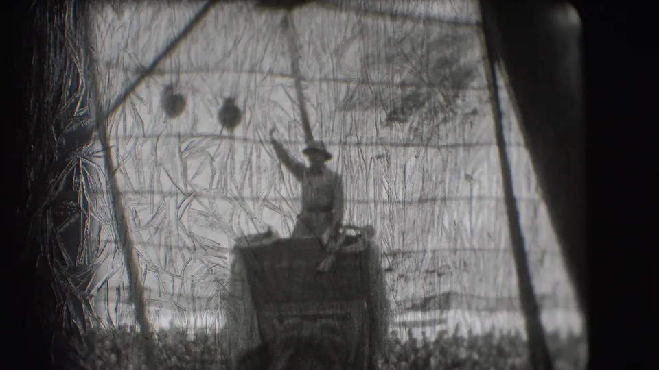 A uniformed rider raises an arm while standing on an elephant in the 1948 Sarasota circus tent footage.