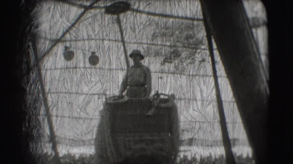 The rider remains upright on the elephant beneath tent ropes and decorations in the black-and-white Sarasota circus footage.