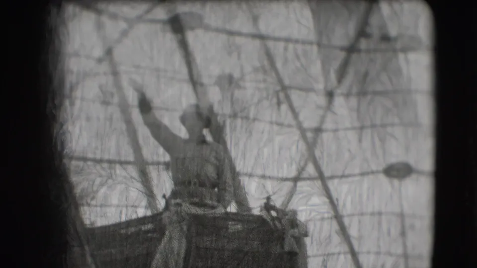 In 1948 Sarasota Ringling Brothers parade footage, a uniformed man stands high on a float and waves through a wire mesh barrier.