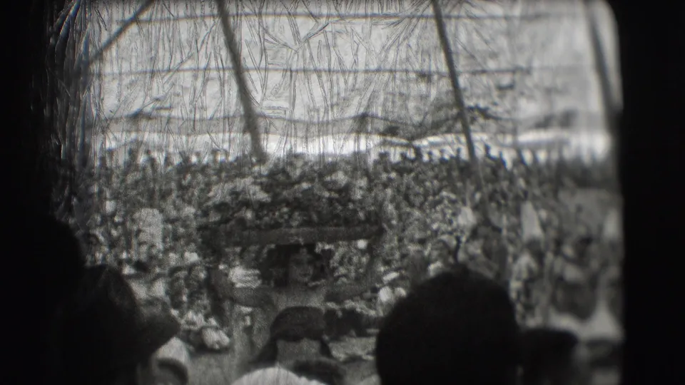 Visitor-shot 1948 circus view with foreground spectators obscuring part of a crowded performance area under the tent.