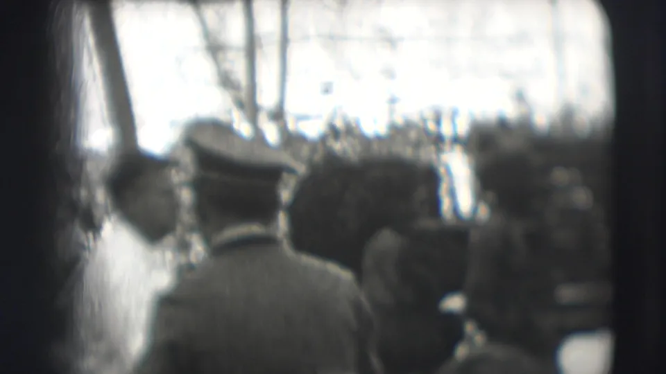 Foreground spectators in hats face a Ringling Brothers circus performance area in Sarasota, partially blocking the home-movie view.