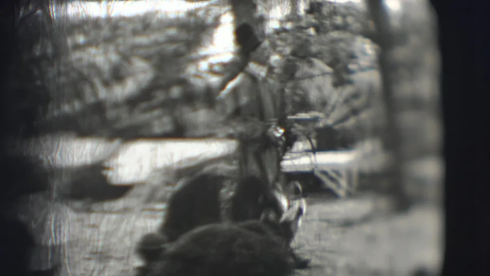 1948 Sarasota circus footage showing a costumed performer near a bear in the ring, viewed from the audience through soft 8mm framing.