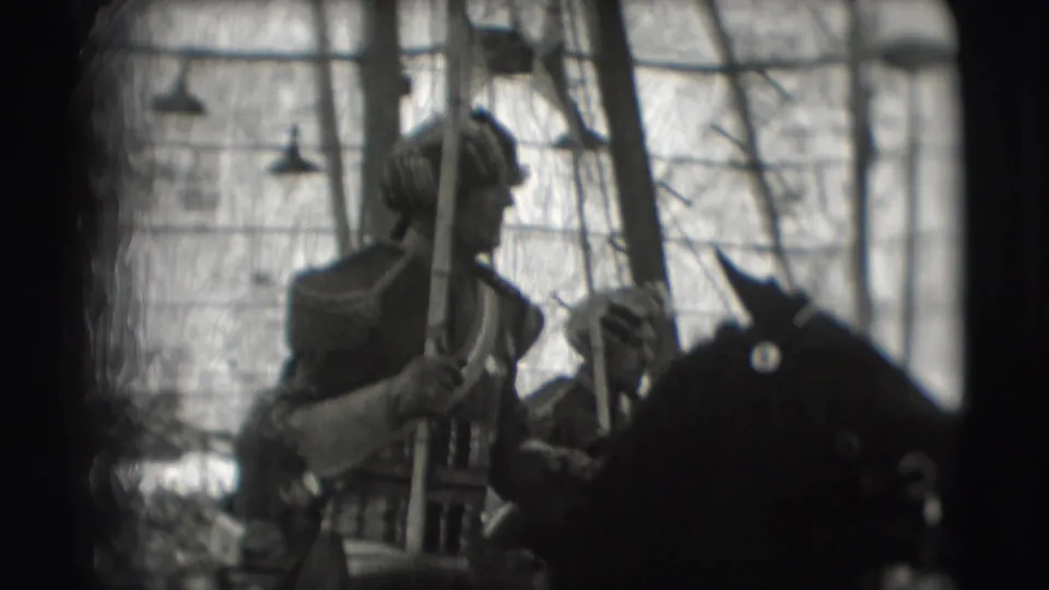 A closer 1948 Sarasota circus frame shows an armored rider holding a lance beside a dark horse inside the tent.