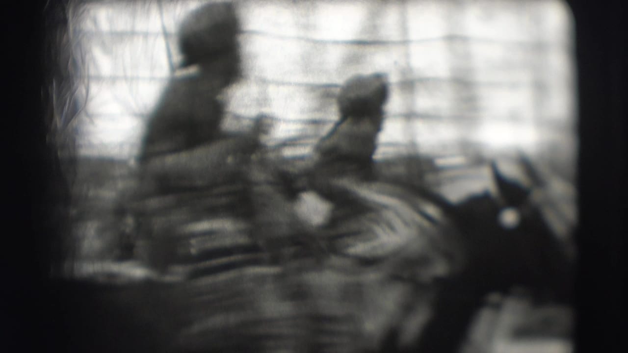 Blurred rider on horseback moving through a tented circus ring.