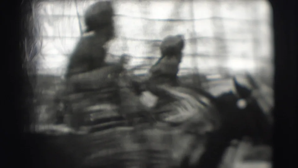 A horse and rider move through the Sarasota circus ring, seen in soft 8mm focus with tent supports behind them.
