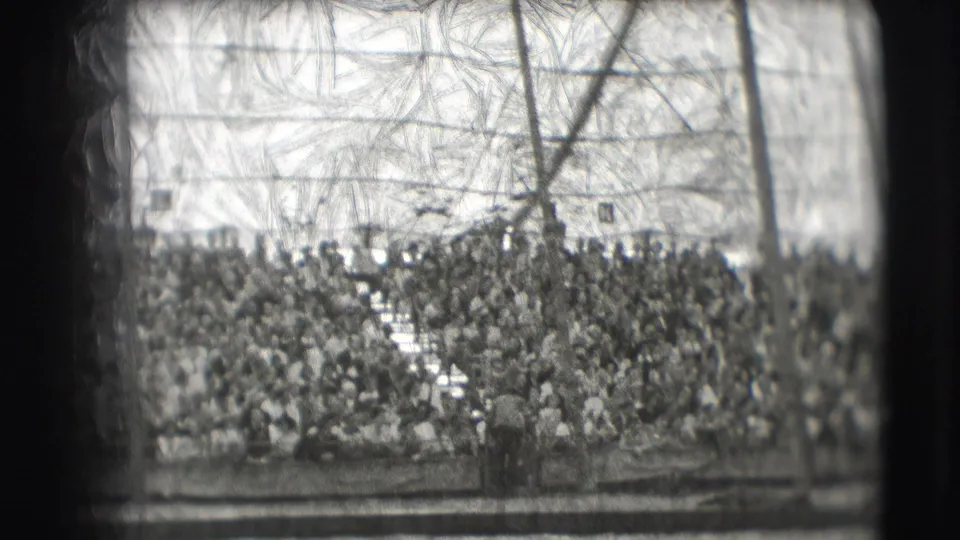 1948 Sarasota circus footage shows a packed audience in stands beyond the arena rail under a large tent structure.