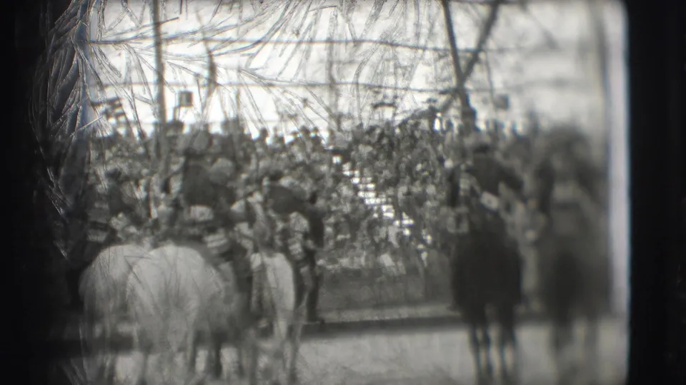 1948 Sarasota circus home-movie frame showing a packed audience and horses in the ring, partly obscured by tent framing.