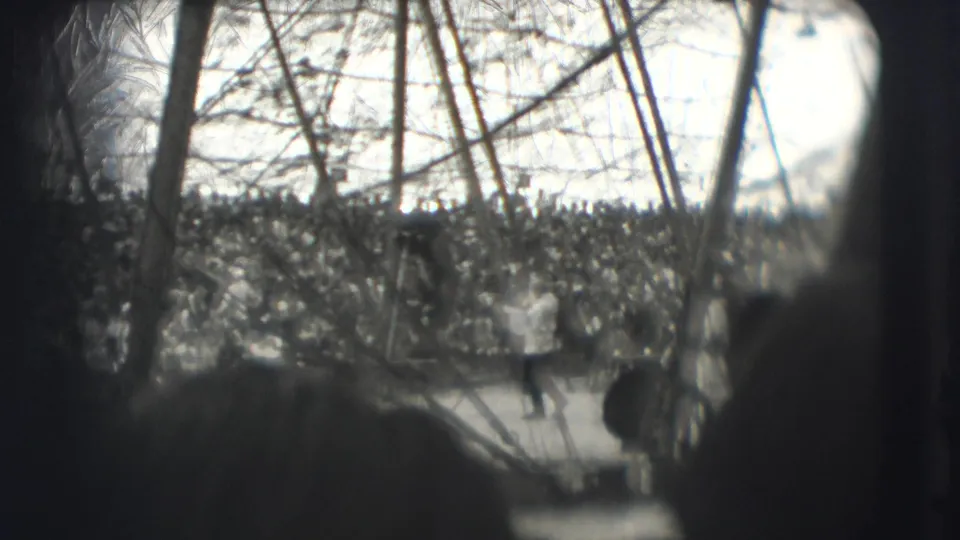 1948 Sarasota circus performance viewed from the audience through canvas supports and foreground spectators.