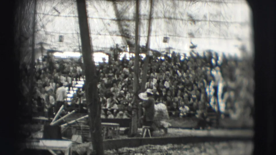 1948 Sarasota circus footage showing packed bleachers, tent poles, and ring activity from a spectator viewpoint.
