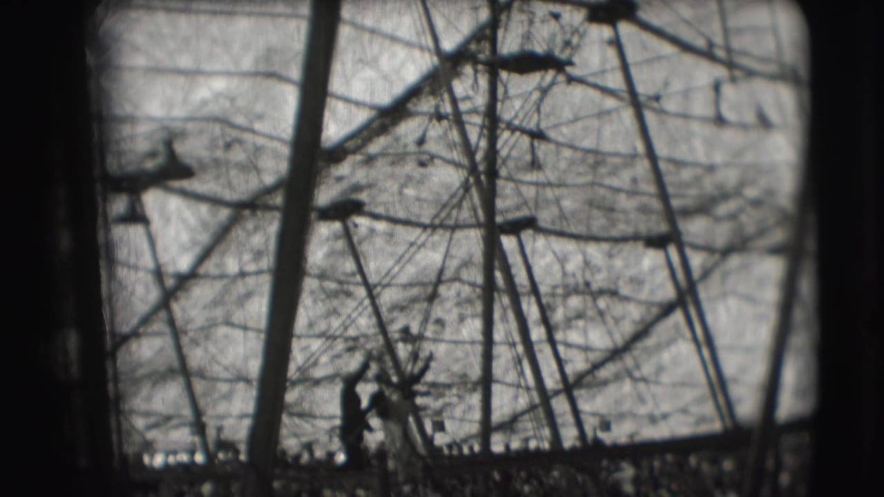 A silhouetted acrobat stands within the high rigging of a 1948 Sarasota Ringling Brothers tent scene.
