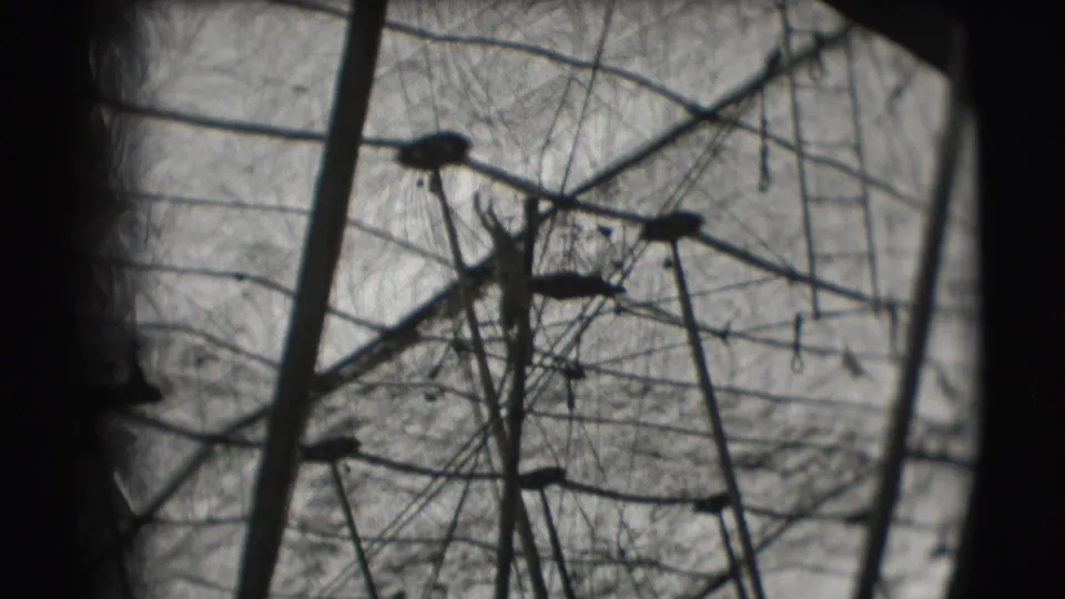 A distant acrobat silhouette appears among high-wire rigging inside the Ringling Brothers Sarasota circus tent in 1948 footage.