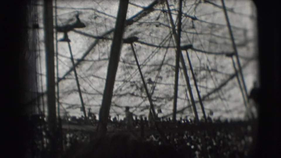 Wide 1948 Sarasota circus frame shows high-wire apparatus, ropes, poles, and dark tent edges with performer details indistinct.