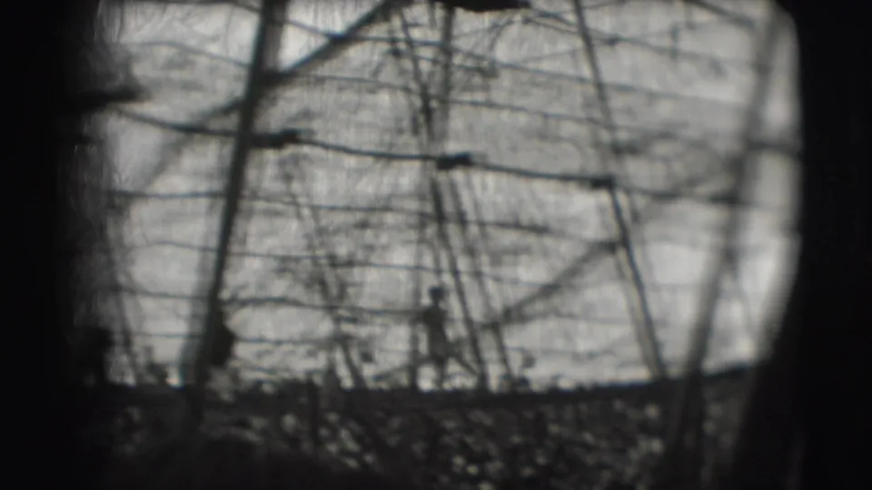 1948 Ringling Brothers Sarasota footage shows a distant silhouetted man amid ropes, poles, and bare branches on an outdoor obstacle course.