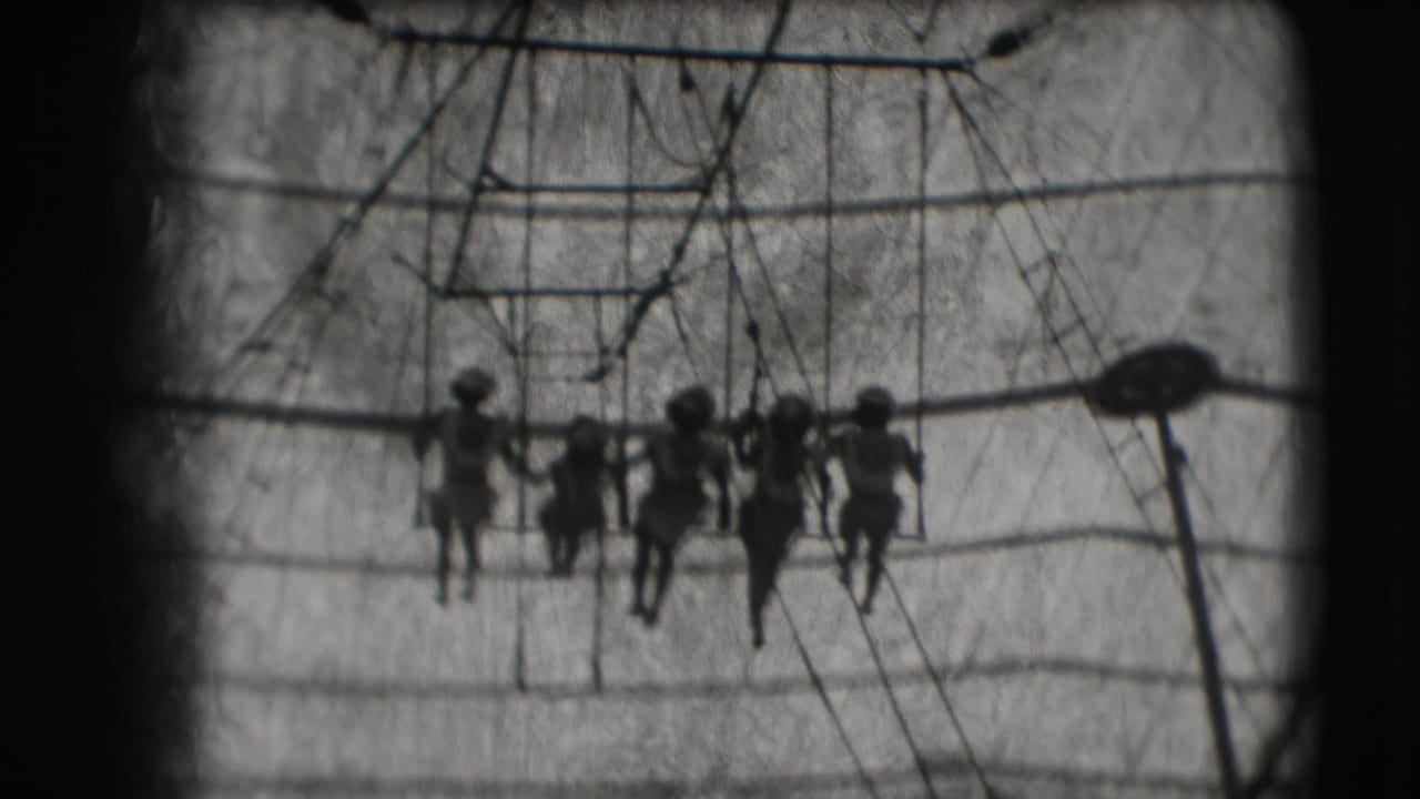 1948 Ringling Brothers Sarasota footage showing women on a trapeze swing under canvas, seen in dark silhouette.