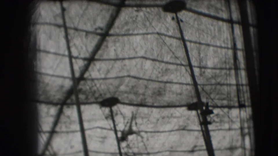 1948 Ringling Brothers Sarasota frame with tent ropes, trapeze hardware, and a distant performer silhouette.