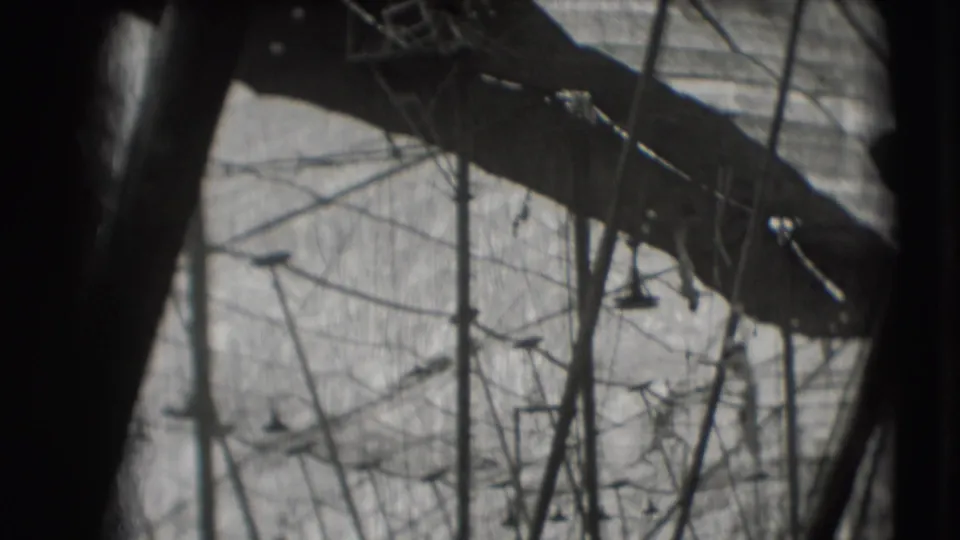 1948 Ringling Brothers Sarasota practice view with trapeze lines, poles, and a dark overhead beam in a soft 8mm frame.
