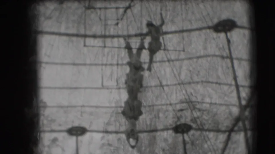 One woman hangs inverted below the trapeze rig while another performer stands above on the apparatus in the 1948 circus scene.