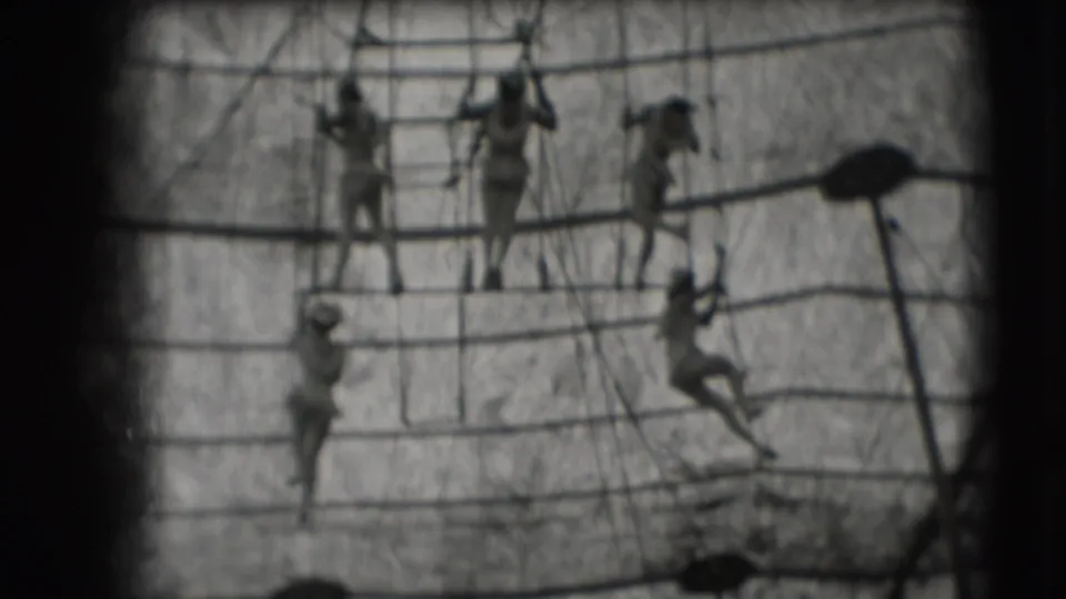 Multiple women performers use ropes and bars across the 1948 Sarasota circus trapeze rig, with one figure hanging lower at right.