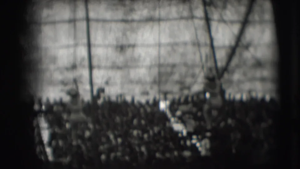 A circus performer is visible on a rope against the tent canvas, with the audience and rigging partly silhouetted below.