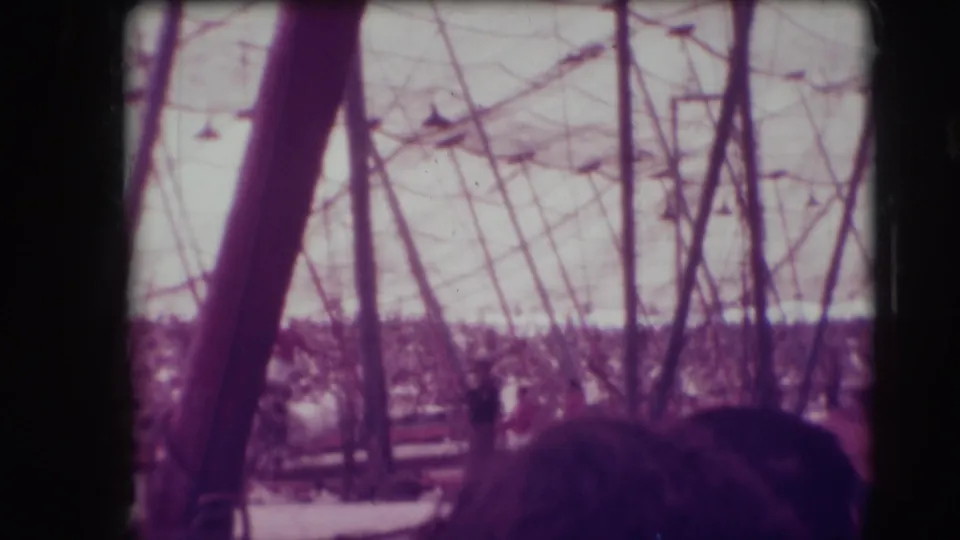 1948 Ringling Brothers Sarasota audience view with tent poles, rigging, packed stands, and a partly obscured horse act in the ring.