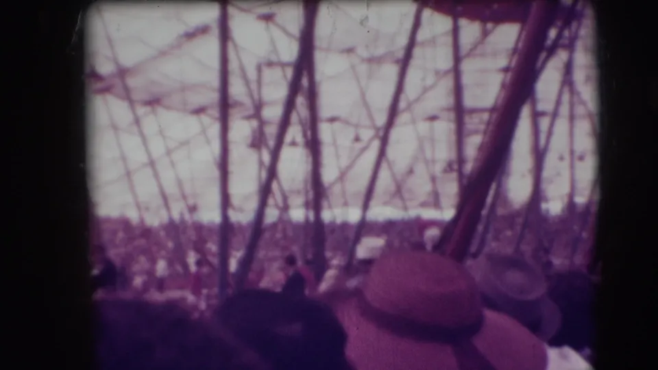 1948 Ringling Brothers Sarasota audience perspective with hats, tent poles, rigging, and crowded stands around the ring.