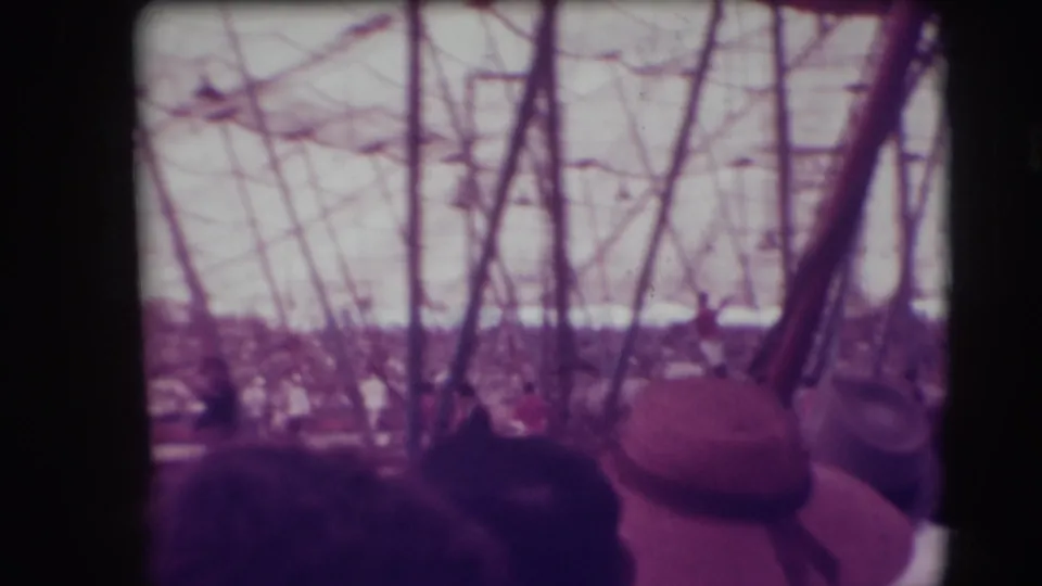 1948 Sarasota circus audience seen from behind under trapeze rigging and tent poles during a Ringling Brothers performance.