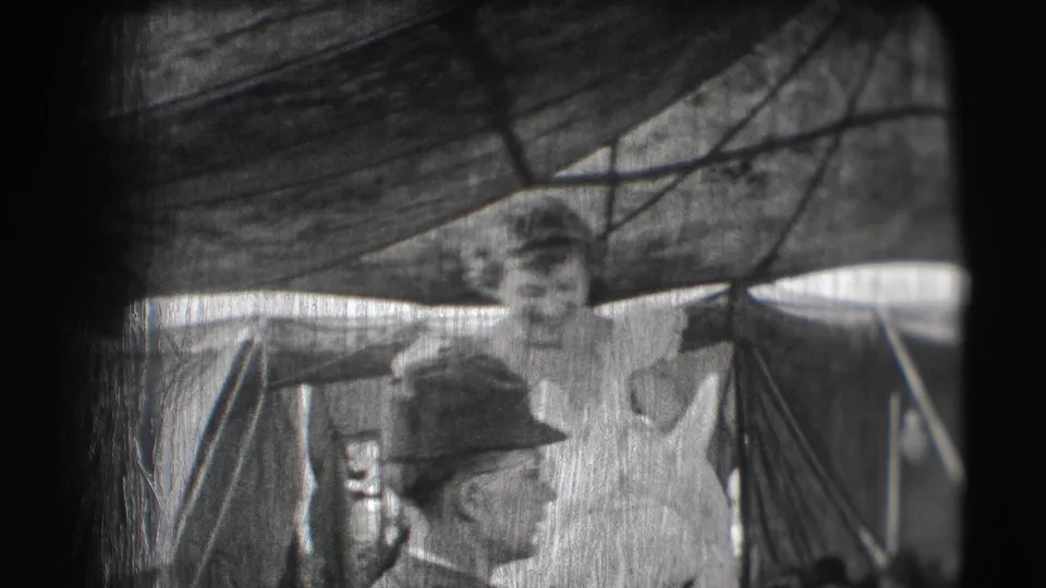 A smiling woman in a light flounced dress stands beside a horse under a circus tent in the 1948 Sarasota scene.