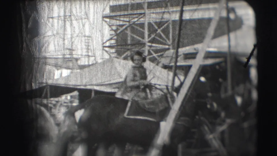 A rider or handler on horseback appears near circus tents, ladders, and scaffolded structures at the Sarasota Ringling Brothers grounds.