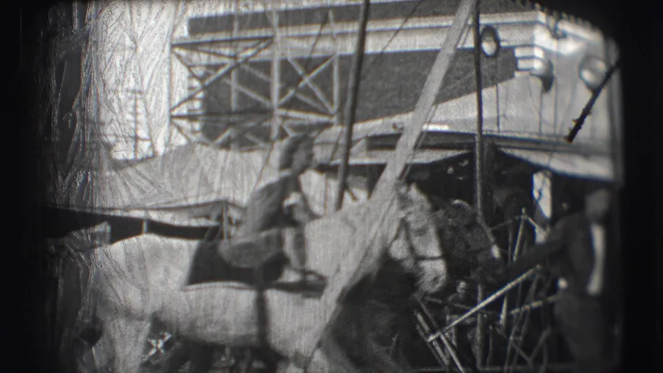 Handlers and a horse stand near tent fabric, ladders, scaffolding, and railings in 1948 Sarasota circus home-movie footage.