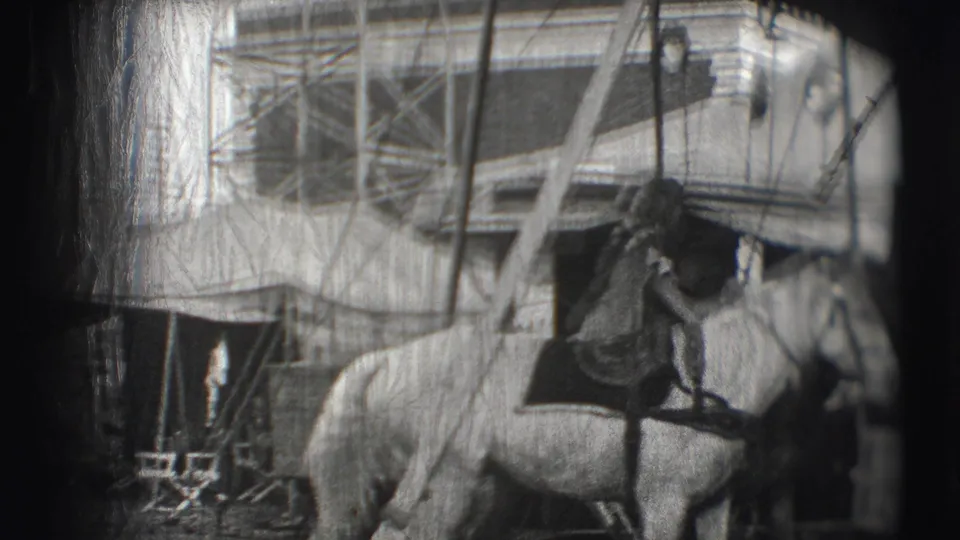 1948 Sarasota Ringling Brothers footage appears to show a handler or rider with a white horse beside tents, ropes, and backstage equipment.