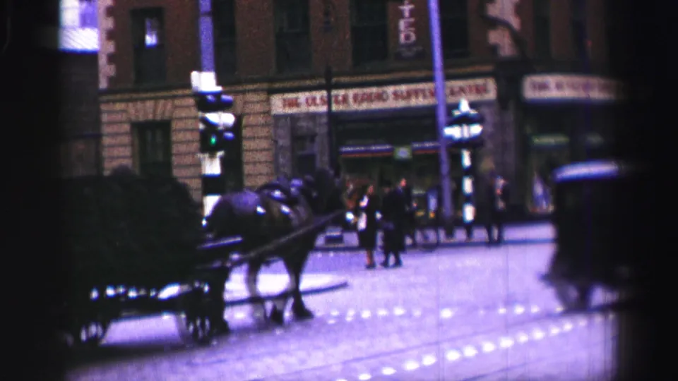A wider night street view shows the horse cart near pedestrians, lit windows, streetlamps, and partly legible storefront signage.