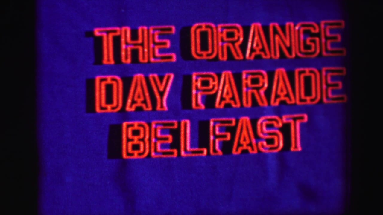 Blue title card with red text reading THE ORANGE DAY PARADE BELFAST.