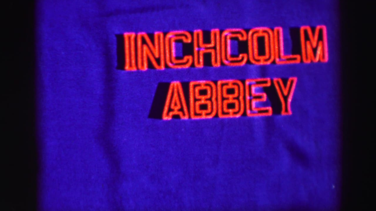 1950s-style 8mm title card with red Inchcolm Abbey lettering on a deep blue background.