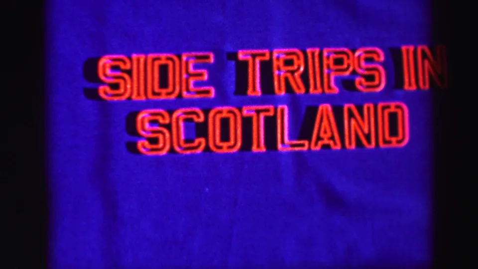 1952 travel-film title card reading “SIDE TRIPS IN SCOTLAND,” shown in red outlined text against a blue field.