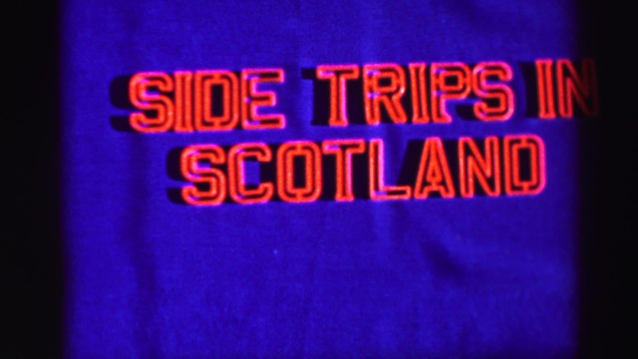 1952 8mm travel-title frame with red lettering reading “Side Trips in Scotland” against a blue projected field.