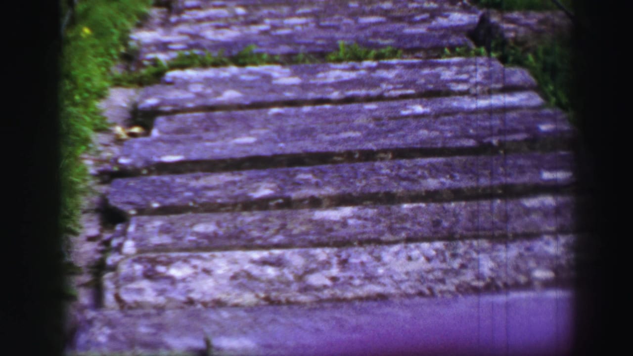 The 1952 coastal walkway appears closer, with aged boards, grass margins, and a black railing visible near the path.