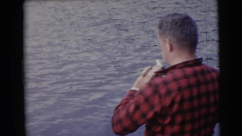 The final frame shows the fisherman from behind in red plaid, seated or crouched near the lake surface in the same Wisconsin boat scene.