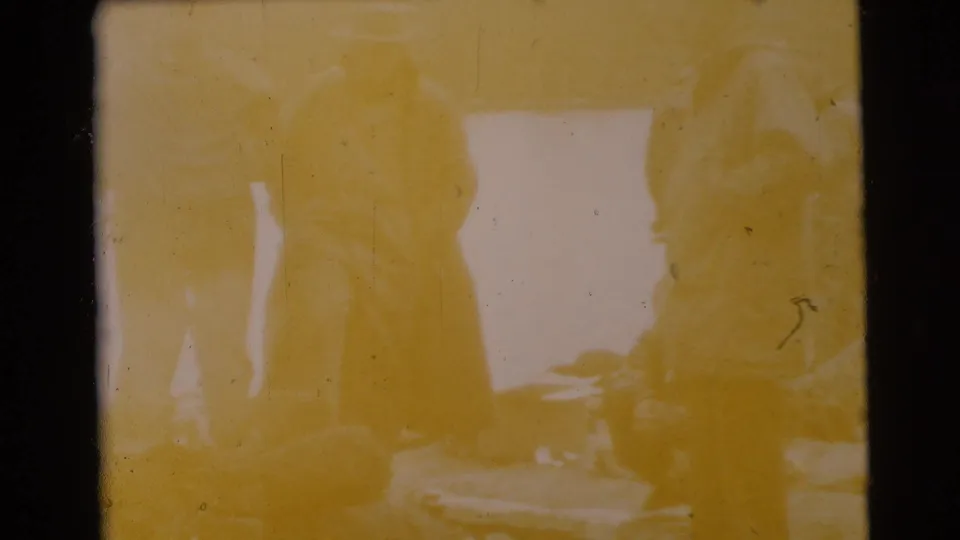 Overexposed 1956 Miami home-movie frame with faint figures and strong yellow-orange color shift.