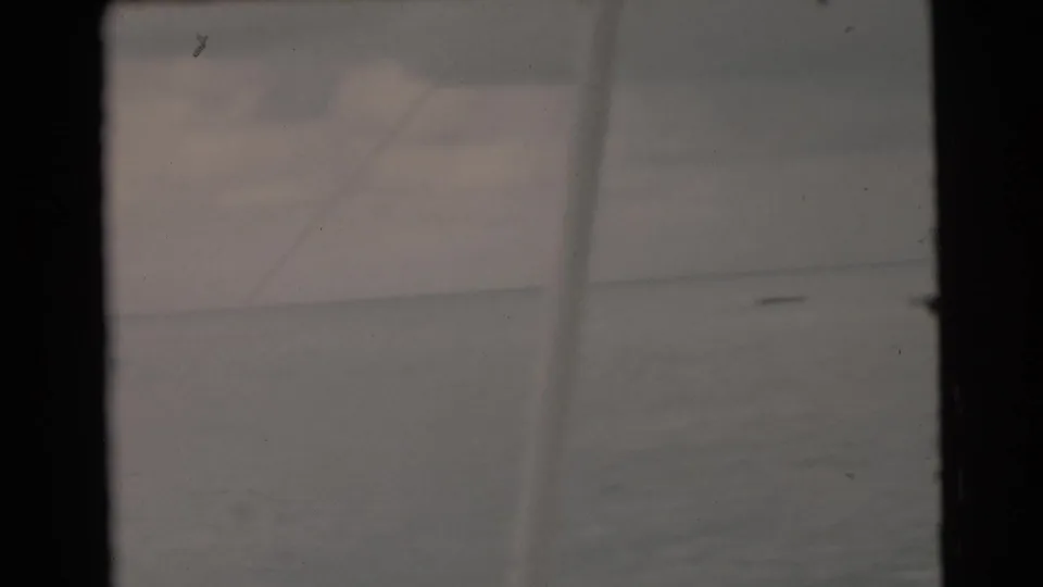 1956 Miami-area 8mm view of open water and a cloudy sky, framed by the scan edges and light film wear.