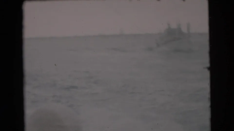 Soft 1956 Miami ocean view with a distant vessel near the horizon and blurred foreground water.